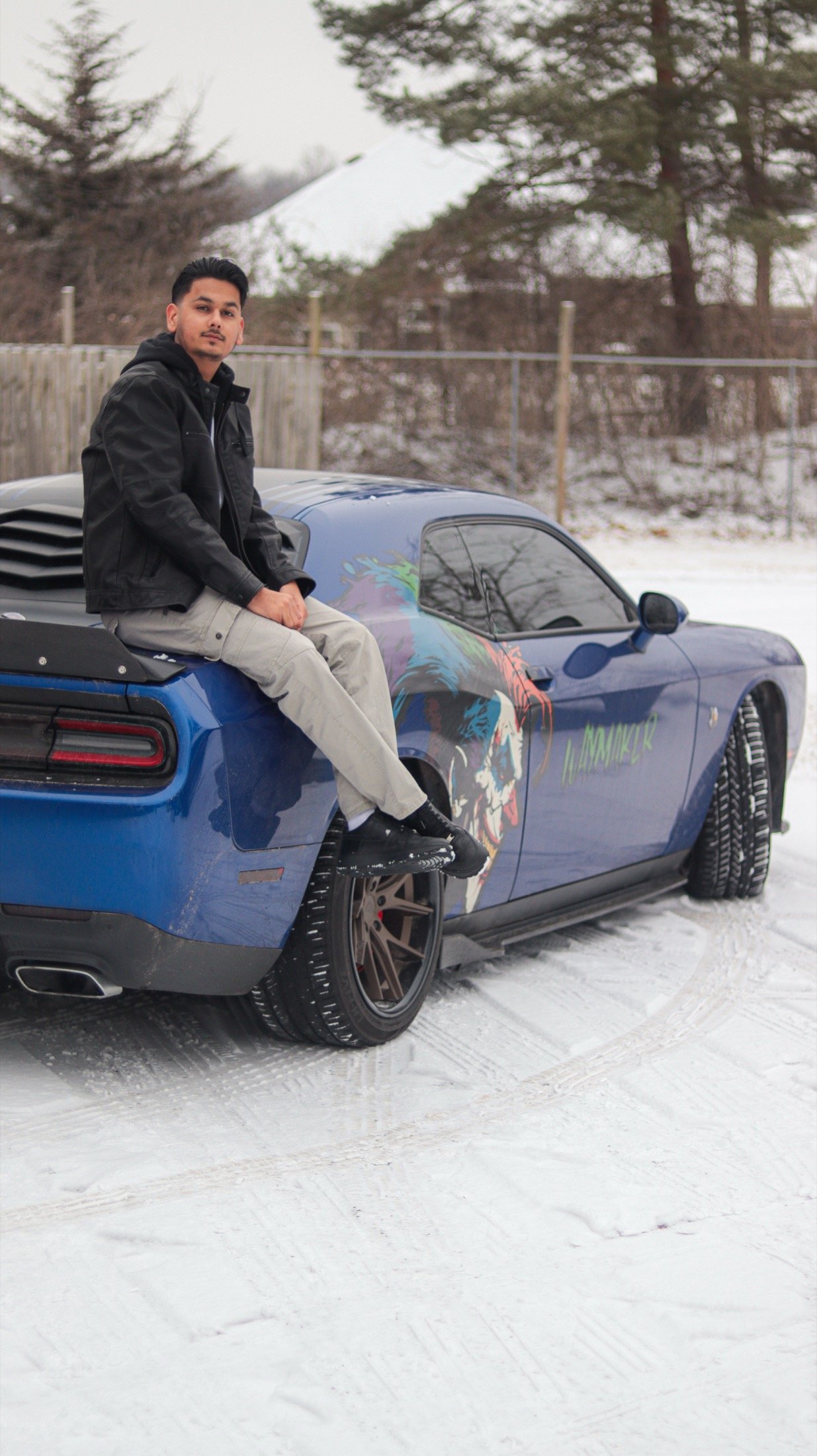 Sanchit Gogna seated by a blue car